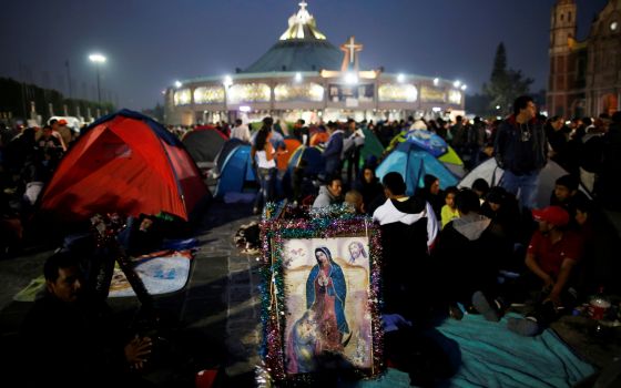 Pilgrims rest beside an image of Our Lady of Guadalupe Dec. 11, 2018, the eve of her feast day at the Basilica of Our Lady of Guadalupe in Mexico City. (CNS)
