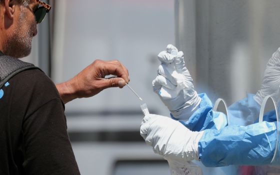 A homeless man in Los Angeles is tested for the coronavirus disease at a fire department testing station April 21. (CNS/Reuters/Lucy Nicholson)