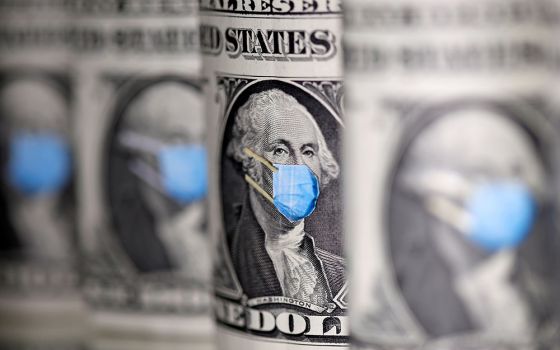 U.S. dollars are seen with face masks during the coronavirus pandemic in this illustration photo. A survey commissioned last fall by the Catholic Extension, which works to support Catholic communities in the poorest regions of the country, found that 13 o