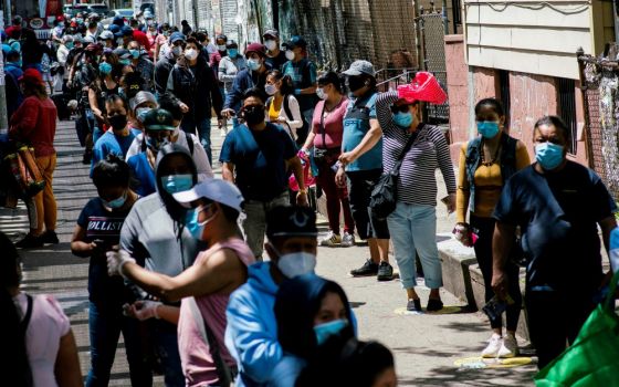 People in the Queens borough of New York City line up during a food distribution May 16. (CNS/Reuters/Eduardo Munoz)