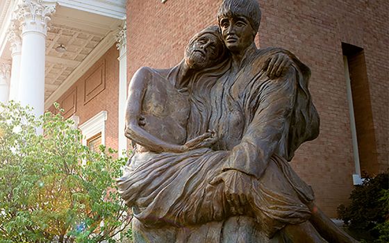 A statue of St. Aloysius Gonzaga carrying a plague victim in his arms is seen on the campus of Gonzaga University in Spokane, Wash., in this undated photo. (CNS/Courtesy of Gonzaga University)