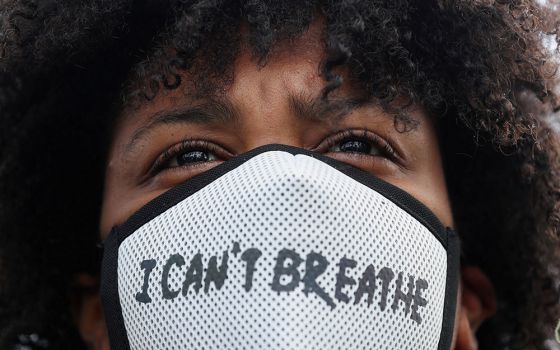 A demonstrator wearing a protective mask takes part in a protest in Rotterdam, Netherlands, June 3, 2020, following the death of George Floyd. (CNS/Reuters/Eva Plevier)