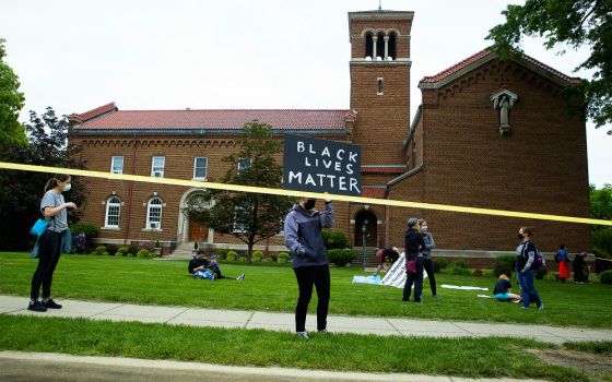 A demonstrator holds a "Black Lives Matter" sign in Washington June 2. (CNS/Tyler Orsburn)