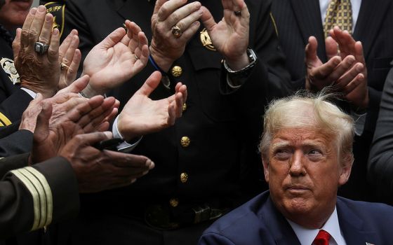 President Donald Trump listens to applause after signing an executive order on police reform at the White House in Washington June 16, 2020. (CNS/Reuters/Leah Millis)