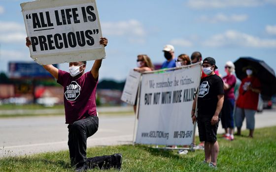 Demonstrators are seen near the Federal Correctional Complex in Terre Haute, Indiana, to show their opposition to the death penalty July 13, 2020. (CNS/Bryan Woolston, Reuters)