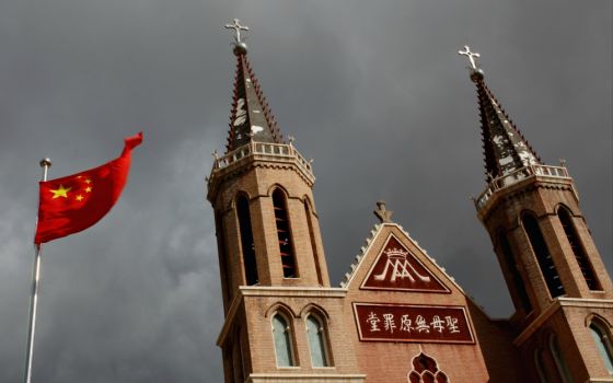 The Chinese national flag flies in front of a Catholic church in Huangtugang, China, in 2018. (CNS/Reuters/Thomas Peter)