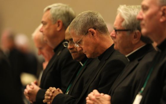 Archbishop Paul Etienne of Seattle, center, and other prelates pray during the fall general assembly of the U.S. Conference of Catholic Bishops Nov. 12, 2019, in Baltimore. (CNS)