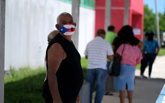 A voter in Loiza, Puerto Rico, waits to cast his ballot Aug. 16, 2020. (CNS/Reuters/Ricardo Arduengo)