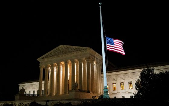 The American flag flies at half staff outside of the U.S. Supreme Court in Washington Sept. 18 following the death of U.S. Supreme Court Justice Ruth Bader Ginsburg. (CNS/Reuters/Al Drago)