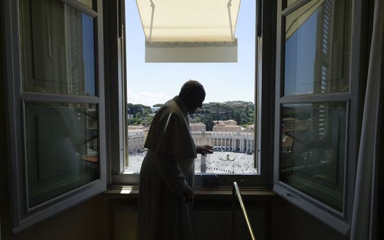 Pope Francis finishes leading the "Regina Coeli" from the window of his studio overlooking St. Peter's Square May 31 at the Vatican. Church officials released the 2019 budget report Oct. 1. (CNS/Vatican Media)