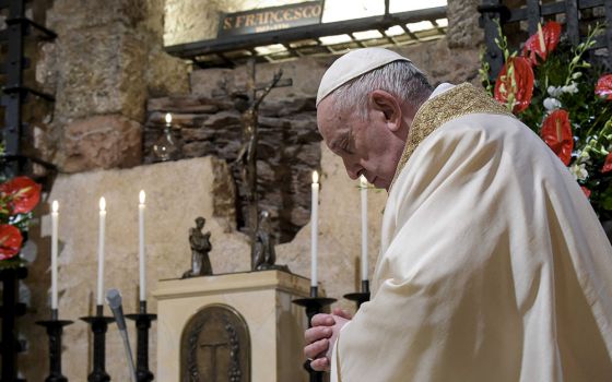Pope Francis celebrates Mass at the tomb of St. Francis in the crypt of the Basilica of St. Francis Oct. 3 in Assisi, Italy. The pope signed his new encyclical, "Fratelli Tutti, on Fraternity and Social Friendship," at the end of the Mass. (CNS/Vatican Me