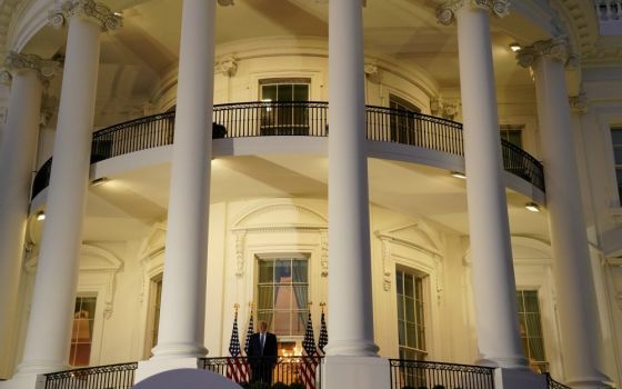 President Donald Trump poses atop the Truman Balcony of the White House in Washington Oct. 5. (CNS/Reuters/Erin Scott)