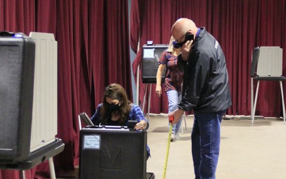 Volunteers in Fort Wayne, Indiana, set up voting machines Oct. 5 for early voting. (CNS/Today’s Catholic/Jodi Marlin)