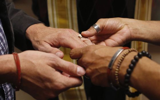 A file photo shows a same-sex couple exchanging rings during a ceremony in Salt Lake City. (CNS/Reuters/Jim Urquhar)