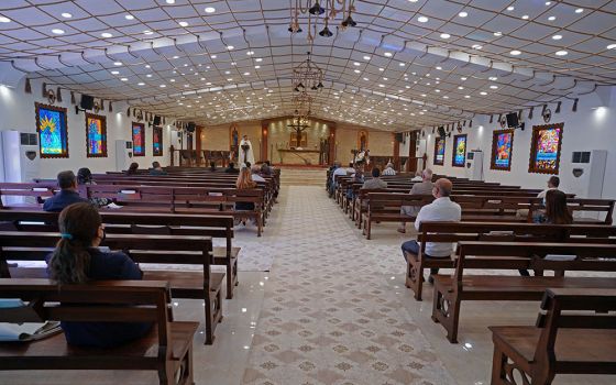 People maintain social distancing while attending Mass at a church in Mosul, Iraq, Nov. 1, 2020, during the COVID-19 pandemic. Pope Francis plans to visit Iraq March 5-8, 2021. (CNS/Reuters/Abdullah Rashid)