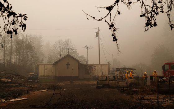 Firefighters in Detroit, Oregon, assess wildfire damage to a church Sept. 14, 2020, in the aftermath of the Beachie Creek Fire. (CNS/Reuters/Shannon Stapleton)