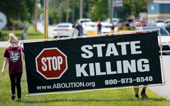 Demonstrators are seen near the Federal Correctional Complex in Terre Haute, Ind., showing their opposition to the death penalty July 13, 2020. (CNS photo/Bryan Woolston, Reuters)