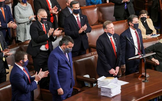 Rep. Paul Gosar, R-Ariz., right, and Sen. Ted Cruz, R-Texas, receive applause from Republicans inside the House Chamber on Capitol Hill Jan. 6 in Washington, for objecting to Arizona's votes during a joint session to certify the 2020 presidential election
