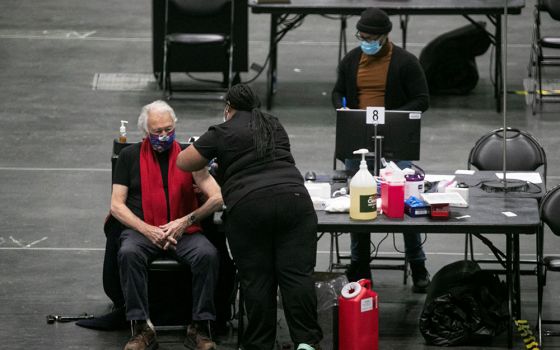 A man at the New York state COVID-19 vaccination site, the Jacob K. Javits Convention Center in New York City, receives a dose of the coronavirus vaccine Jan. 13. (CNS/Reuters/Brendan McDermid)