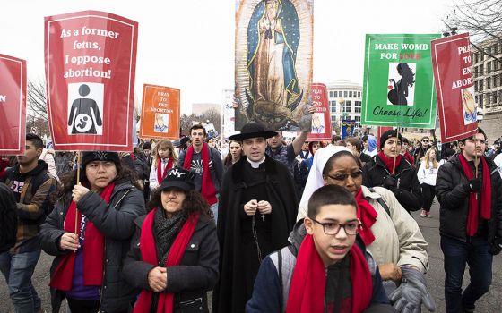 People walk up Constitution Avenue headed toward the U.S. Supreme Court while participating in the 47th annual March for Life Jan. 24, 2020, in Washington. The 2021 March for Life in Washington will be held virtually because of the coronavirus pandemic an