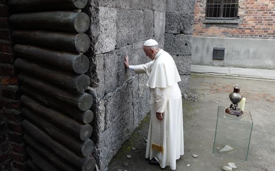 Pope Francis touches the death wall at the Auschwitz Nazi death camp in Oswiecim, Poland, in this July 29, 2016, file photo. (CNS/Paul Haring)