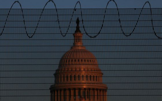The U.S. Capitol is seen in Washington Jan. 28 behind steel fencing topped with razor wire. (CNS/Reuters/Leah Millis)