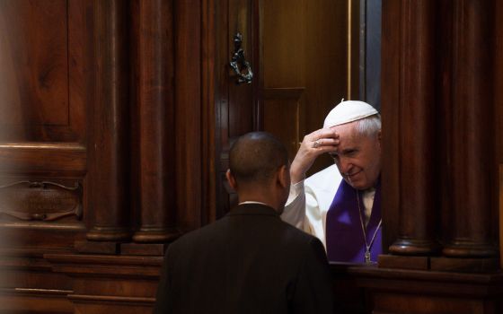 Pope Francis hears the confession of a priest at the Basilica of St. John Lateran in Rome, March 7, 2019. (CNS photo/Vatican Media)