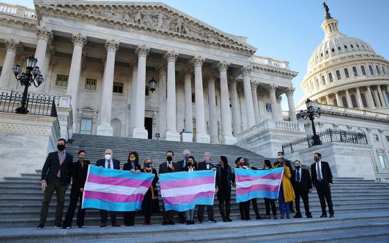 Democratic members of the U.S. House of Representatives pose for a photograph holding Transgender Pride flags on Capitol Hill in Washington Feb. 25, ahead of a vote on the Equality Act. (CNS/Reuters/Tom Brenner)