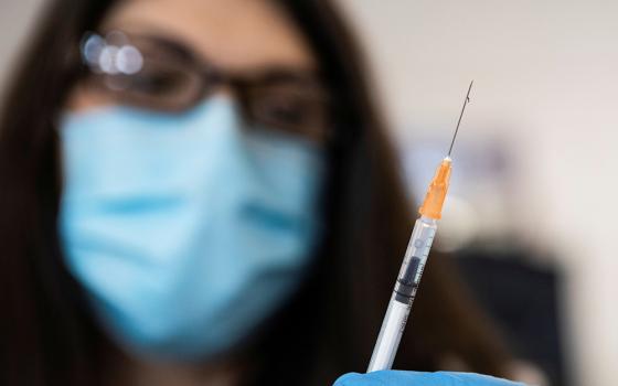 A nurse in Richmond, Virginia, readies a syringe with the COVID-19 vaccine at the Richmond Raceway complex March 4. (CNS/Julia Rendleman, Reuters)