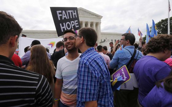 Supporters of same-sex marriage celebrate outside the U.S. Supreme Court building in Washington June 26, 2015, after the justices ruled in a 5-4 decision that the U.S. Constitution gives same-sex couples the right to marry. Over 3,000 Catholic theologians