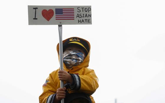 A child in Bellevue, Washington, holds a sign during a "Stop Asian Hate" rally and vigil March 20, following the deadly shootings March 16 at three Asian day spas in metro Atlanta. (CNS/Reuters/Lindsey Wasson)