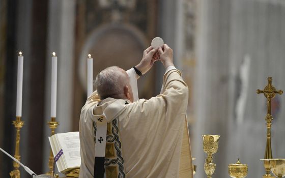 Pope Francis elevates the Eucharist during Easter Mass in St. Peter's Basilica at the Vatican April 4. (CNS/Vatican Media)