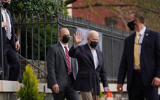 President Joe Biden waves as he departs Holy Trinity Catholic Church April 10 in Washington. (CNS/Erin Scott, Reuters)