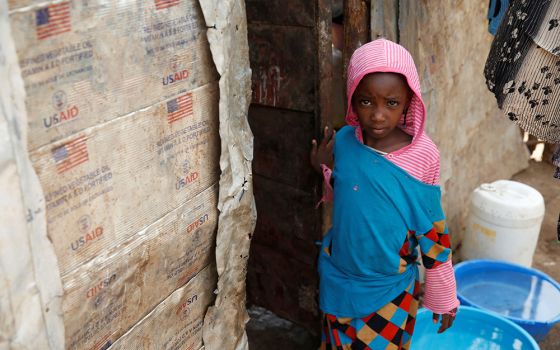 A girl stands outside a makeshift shelter in 2018 at the Kakuma refugee camp in northern Kenya. (CNS/Reuters/Baz Ratner)