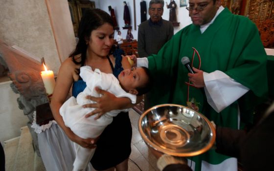A child is pictured in a file photo being baptized at a church in Mexico City. (CNS/Reuters/Edgard Garrido)