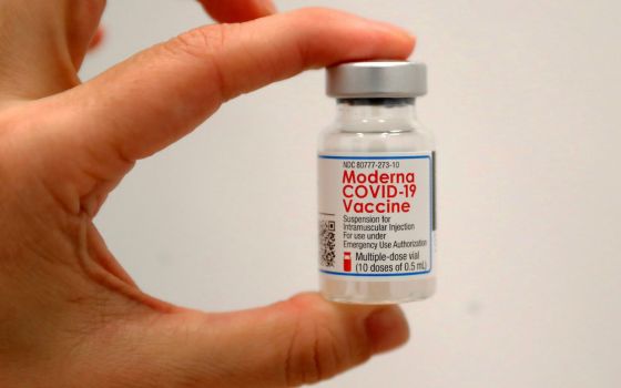 A health care worker holds a vial of the Moderna COVID-19 vaccine at a pop-up vaccination site operated by SOMOS Community Care during the COVID-19 pandemic New York in this Jan. 29 file photo. (CNS/Reuters/Mike Segar)