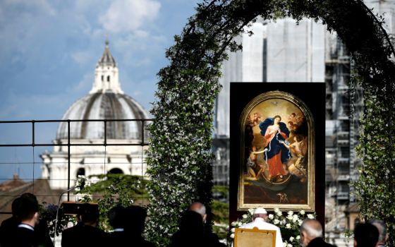 Pope Francis, seated before an image of Our Lady, Undoer of Knots, leads an evening Marian prayer service in the Vatican Gardens May 31. (CNS/Filippo Monteforte, Reuters pool)
