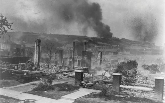 Smoke rises from the ruins of African Americans' homes following the 1921 race massacre in Tulsa, Oklahoma. (CNS/Library of Congress, Handout via Reuters/National Association for the Advancement of Colored People Records/Alvin C. Krupnick Co.)