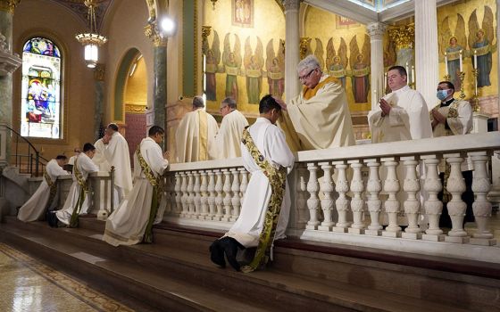Four ordinands kneel as priests lay hands on them during their ordination to the priesthood June 5 at the Co-Cathedral of St. Joseph in Brooklyn, New York. (CNS/Gregory A. Shemitz)