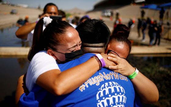 People hug each other as they participate in a reunification event named "Hugs Not Walls" on the border between Ciudad Juarez, Mexico, and El Paso, Texas, June 19, 2021. (CNS photo/Jose Luis Gonzalez, Reuters)