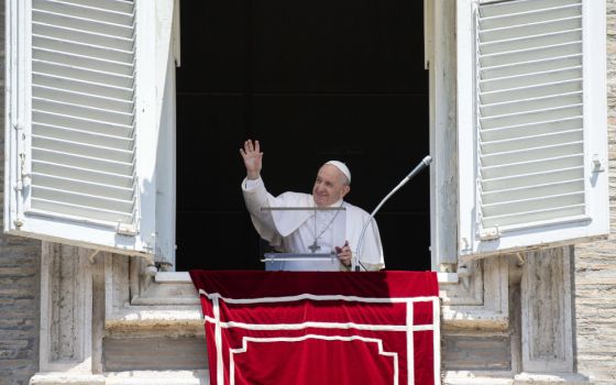 Pope Francis greets the crowd as he leads the Angelus from the window of his studio overlooking St. Peter's Square at the Vatican June 28. (CNS/Vatican Media)