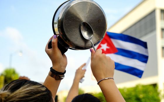 A demonstrator in the Little Havana neighborhood of Miami bangs on a pot July 12, as people rally in solidarity with protesters in Cuba. (CNS/Reuters/Maria Alejandra Cardona)