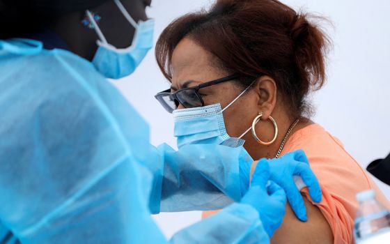 A local resident receives a dose of the Pfizer-BioNTech COVID-19 vaccine during a vaccination event for adolescents and adults outside the Bronx Writing Academy school in New York City June 4. (CNS/Reuters/Mike Segar)