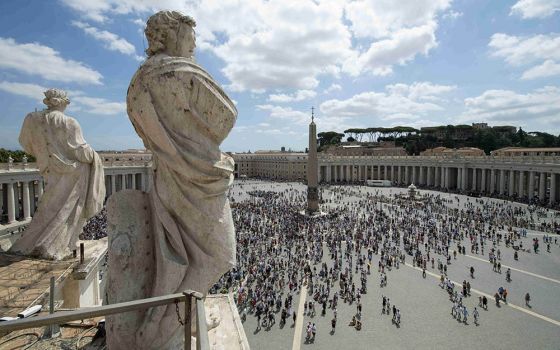 The crowd watches as Pope Francis leads the Angelus message from the window of his studio overlooking St. Peter's Square at the Vatican Aug. 8. In his Angelus message, the pope said Jesus is the "essential bread of life."