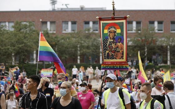 Activists carrying a rainbow flag and a banner with an image of Mary and the Christ Child attend the second "Marzahn Pride" march in Berlin July 17. (CNS/Reuters/Axel Schmidt)