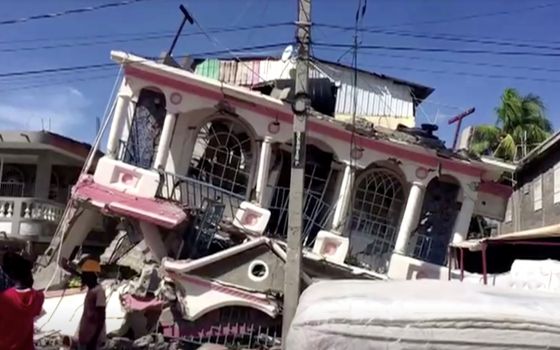 A collapsed building is pictured following a magnitude 7.2 earthquake in Les Cayes, Haiti, in this still image taken from a video Aug. 14, 2021. (CNS photo/Reuters TV)