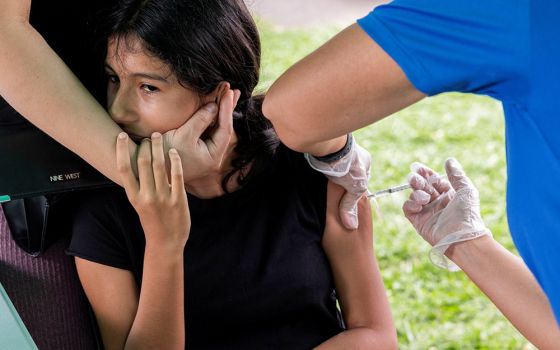 A young person in Bensalem, Pennsylvania, receives the coronavirus vaccine Aug. 22, during an outreach campaign for the Latino community. (CNS/Reuters/Rachel Wisniewski)