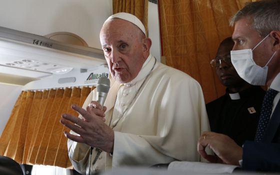 Pope Francis answers questions from journalists aboard his flight from Bratislava, Slovakia, to Rome Sept. 15. (CNS/Paul Haring)