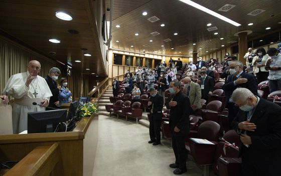 Pope Francis gives his blessing Sept. 16 at the end of a meeting in the Vatican synod hall with members of lay movements. The hall will be the site of the 2023 Vatican event, the final phase of the new process of the Synod of Bishops (CNS/Vatican Media)