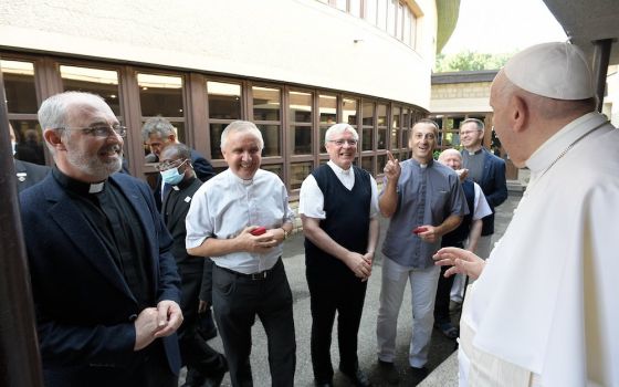 Pope Francis talks with members of the Society of Jesus at the apostolic nunciature in Bratislava, Slovakia, Sept. 12.